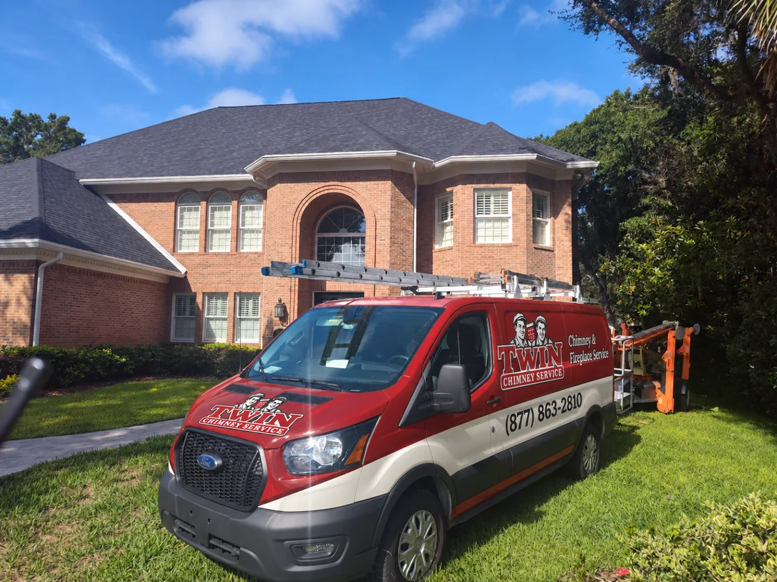 Red and cream van with Twin Chimney Service branding