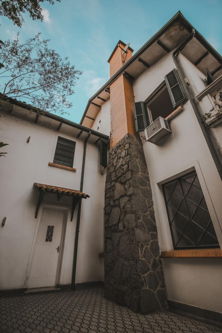 Stone chimney beside the exterior of a house